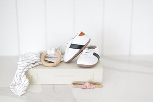 Adorable baby gift set featuring a keepsake journal, stylish leather shoes, soothing teether, and optional accessories. Perfect for showers, birthdays, or just-because!