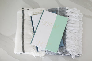 Loom journal gift box with cozy blankets, Custom curated sympathy gifts with blanket and journal, Promptly Loom Parent Child Journal, Couples Journal, Grief Journal, Brushed Cotton Blanket, Cream and Charcoal striped blanket, Charcoal Blue Blanket with Cream Stripe, Gifts that are ready to ship and packaged, Mercy Forest Co. Gifting