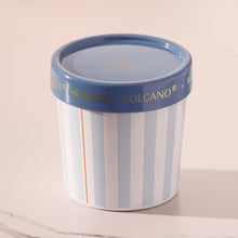 Cylindrical container with striped design and blue lid on a light background