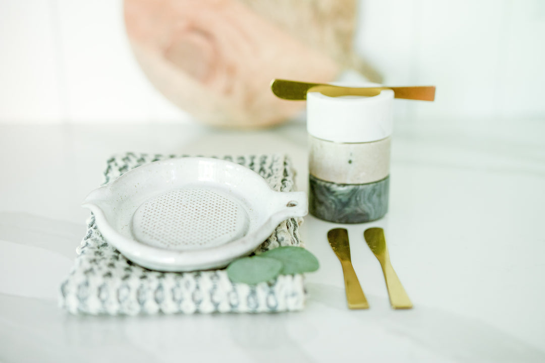 Set of three marble dishes with brass knives, zester/grater, and cotton waffle weave towel. Mercy Forest Co. takes the hassle out of gifting so you can focus on the impact. 