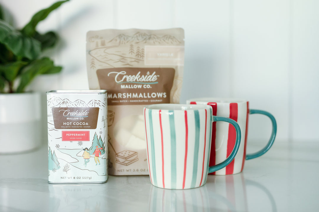 Mercy Forest Co. makes gifting easy with the Coco gift box. Complete with peppermint hot chocolate, white and green and red striped stoneware mugs come in a set of two, and gourmet marshmallows. 