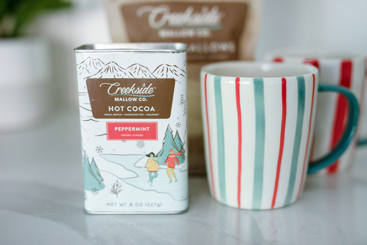 Creekside Mallow Co. Hot Cocoa tin and green red striped mug. white background. Client gifting. Real Estate Advisor. Realty Gifts. Independence MN 