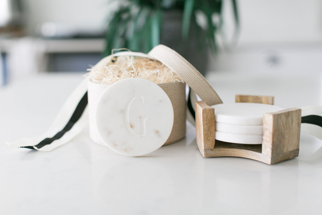 Custom curated new homeowner gift boxes, white marble coasters with acacia wood holder, mercy forest co gifting. Impress your clients, employees, or realtor with a personalized gift they'll treasure. These marble coasters are laser-engraved with your message for a timeless touch.