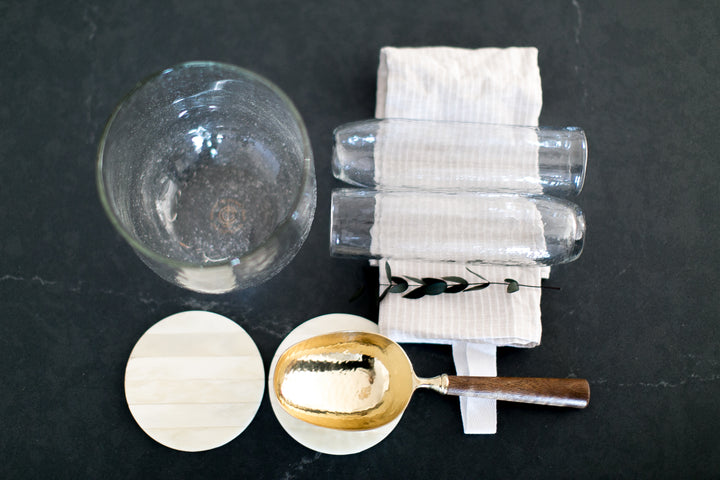 Celebrate that new job, home or college graduate with these stemless champaign flutes, brass and wood ice scoop, glass ice bucket, inlayed bone coaster set and linen tea towel. All from Mercy Forest Co. and ready to ship!