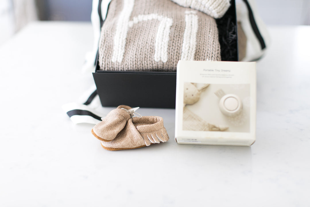 Hatch Rest Go Portable Sound Machine in putty with fringe leather moccasins. Ready to ship to new mother. 