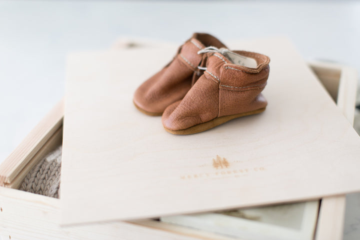 Brown leather moccasins perfect for newborn baby. Scout by Starry Knight.