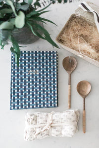 Real estate client gift: Say "thank you" with style! Woven basket filled with an heirloom recipe book and cloth napkins - a practical and personalized gift.