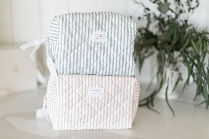 stacked sugar paper zip pouches. Available as an add on to the Nancy gift box by Mercy Forest Co. 