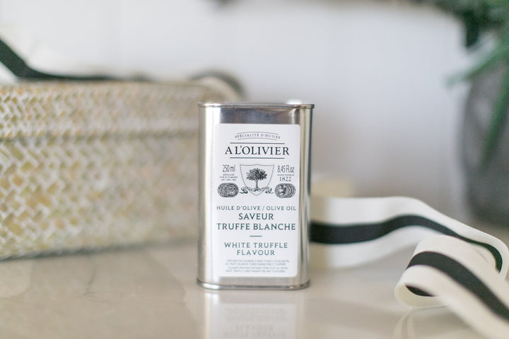 Can of A. Olivier olive oil with white truffle flavor on a table.