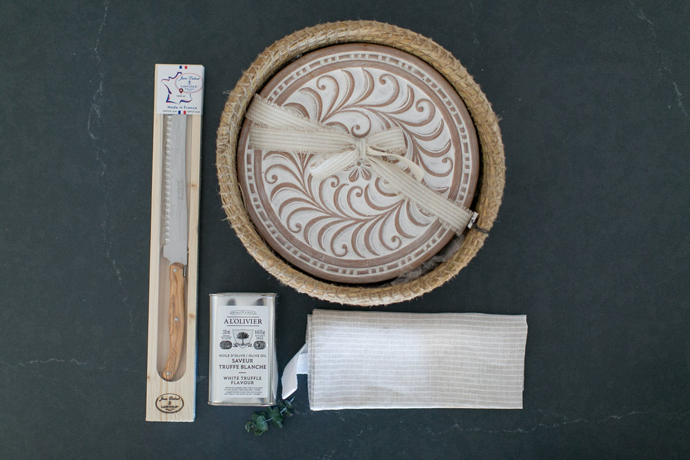 Wooden product with decorative carvings on a dark surface, accompanied by a ruler and packaging.