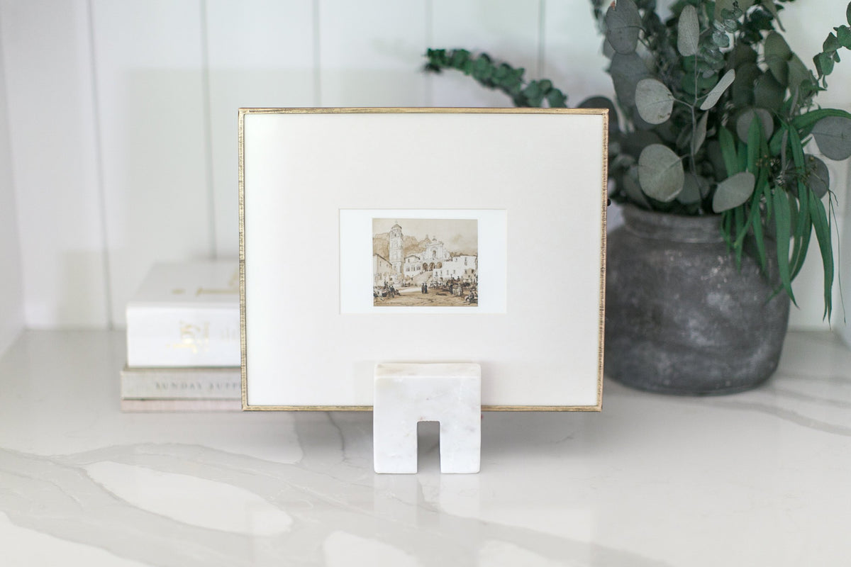 Framed sepia print on a marble counter with eucalyptus — a Mercy Forest Co. executive gift