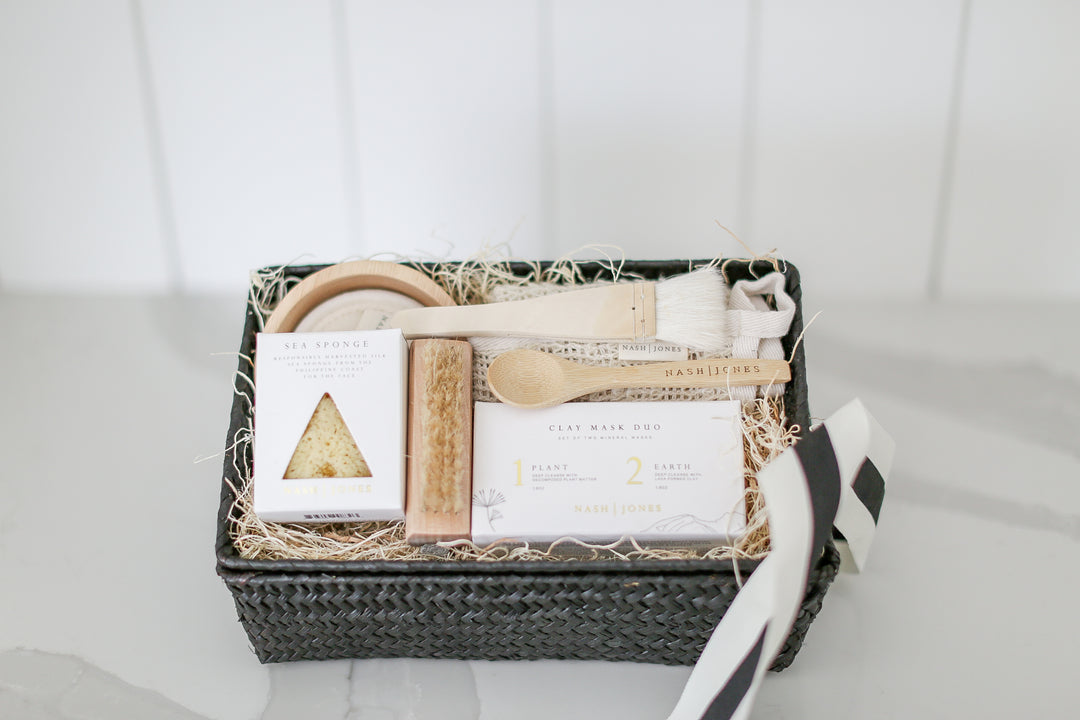 Comfort gift for those in need of self care, includes Nash and Jones clay mask, sea sponge and shower steamers. Gift is ready to ship in black woven basket with lid and ribbon. Mercy Forest Co. gifting. Custom curated gifts that are ready to ship and be delivered, spa inspired gift box with shower steamer options of either lavender or eucalyptus 