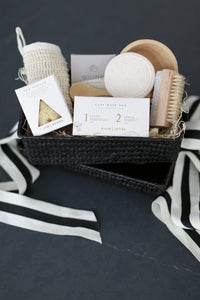 Spa inspired gift box, Comfort gift for those in need of self care, includes Nash and Jones clay mask, sea sponge and shower steamers. Gift is ready to ship in black woven basket with lid and ribbon. Mercy Forest Co. gifting. Custom curated gifts that are ready to ship and be delivered. 