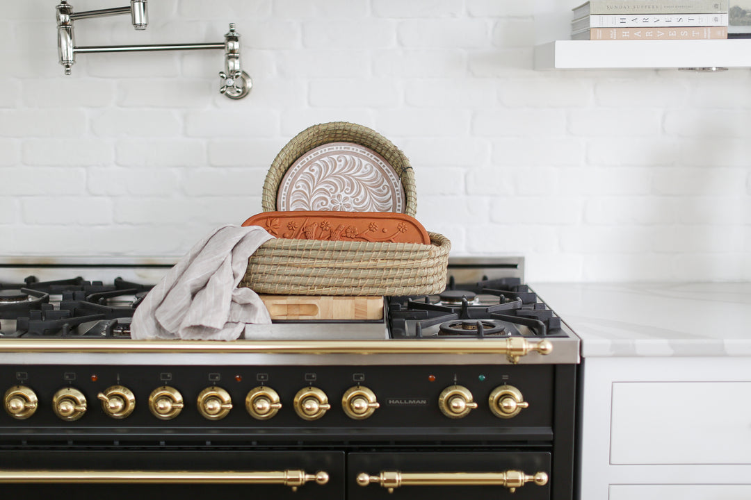 Warm welcome basket for new homeowners: Delight your clients with this thoughtful gift basket featuring delicious gluten-free baguettes and a luxurious linen tea towel, perfect for cozying up in their new home. Mercy Forest Co. 