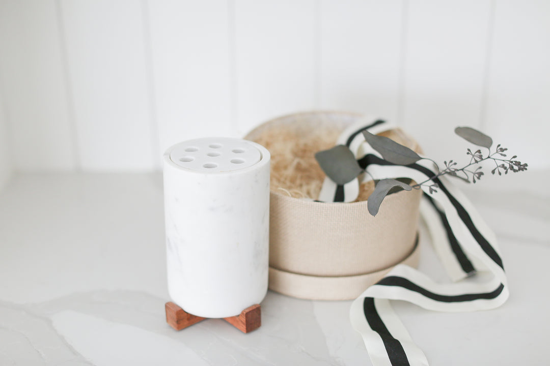 Marble vase with frogger and wood base nestled inside of a round woven gift box. Home closing gifts for realtors in real estate. 