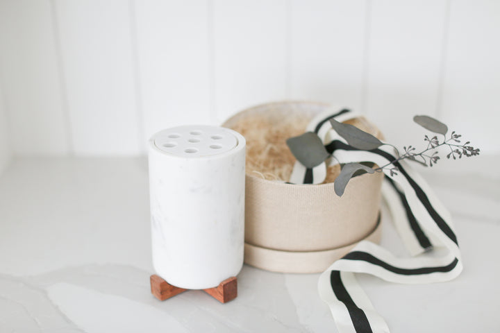 Marble vase with frogger and wood base nestled inside of a round woven gift box. Home closing gifts for realtors in real estate. 