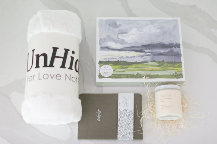 custom curated self care gift box with UnHide blanket, journal, candle, and puzzle. Ready To ship with www.mercyforest.com