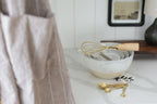 Custom curated gift box for bakers, Custom curated gift box with baking bowls and utensils,  stoneware stacking baking bowls, brass wire whisk, brass measuring spoons, striped apron, Mercy Forest Co., real estate gifting, client gifting ideas