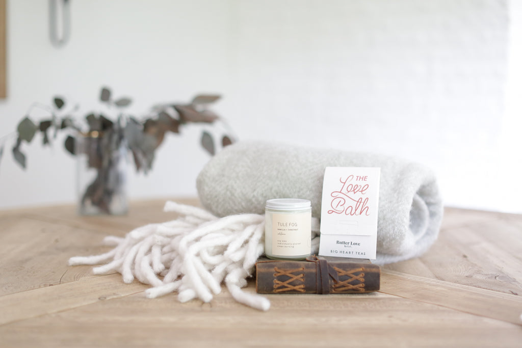 Custom curated comfort gift box with bath bomb, candle, cozy blanket, and journal